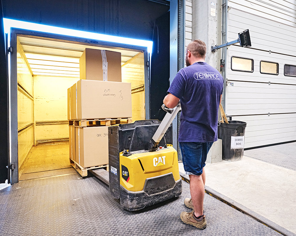 An man loading the boxes into a truck